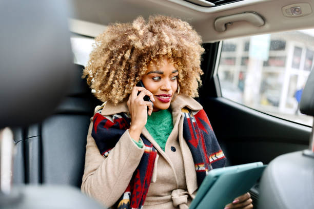 istock Businesswoman using cell phone in the car 1462688880