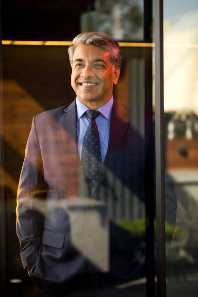 istock Cheerful businessman looking away through glass window 1462699021