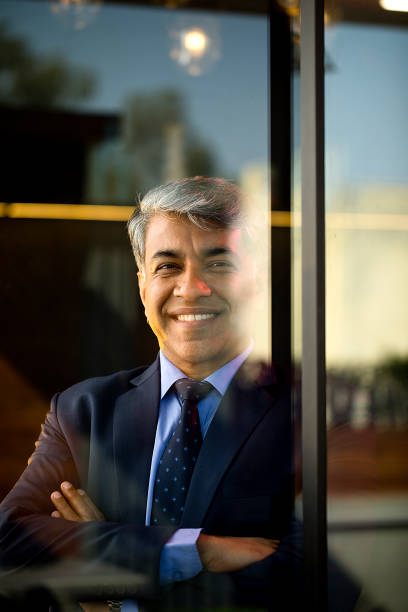 istock Businessman looking away through glass window 1462699601