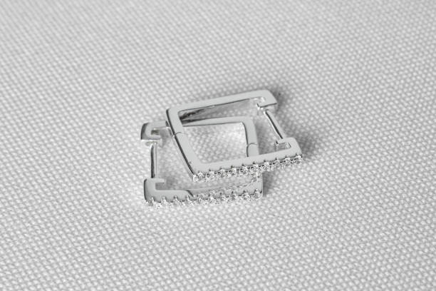 istock Elegant silver earring jewelry with gemstones with square shape. White background. 1462704241