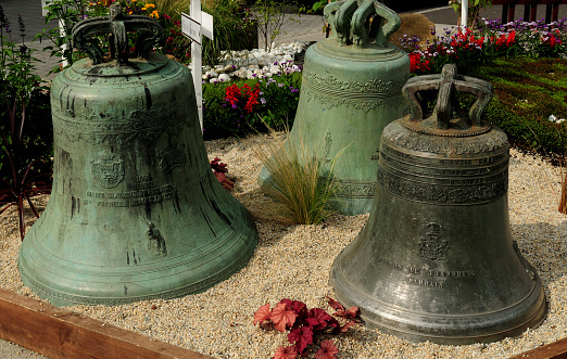 Historic Bells In A Public Park In Villedieu-les-Poeles In Bretagne France On A Beautiful Sunny Summer Day