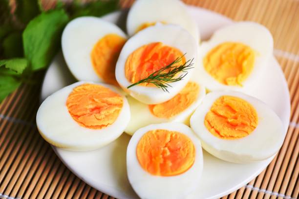 istock Eggs breakfast, fresh eggs menu food boiled eggs in a white plate decorated with leaves green dill background, cut in half egg yolks for cooking healthy eating 1462706406