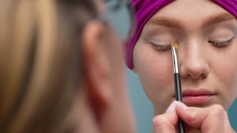 Close-up of eye shadow being applied.