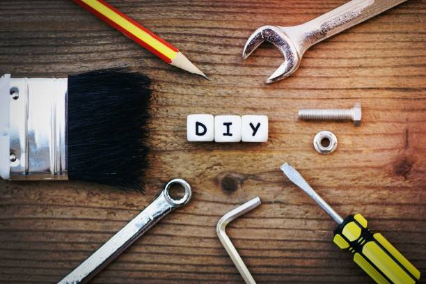 A vibrant 3D illustration capturing the essence of creativity and do-it-yourself projects. This top-down view shows a well-organized workspace with various crafting tools like a utility knife, scissors, and a ruler laid out on a green cutting mat. The acronym \