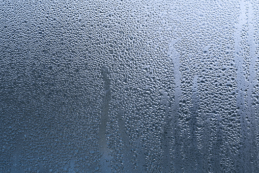 large drops of water on the glass. a sweaty window.