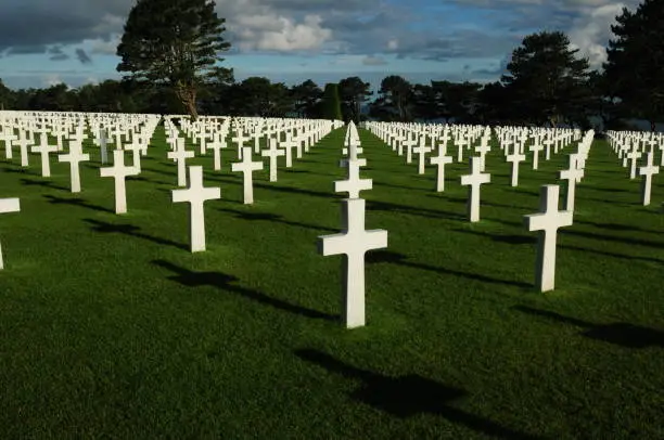 White Crosses For Fallen US Soldiers At The American Cemetery In Normandy France On A Beautiful Sunny Summer Day With A Few Clouds In The Sky