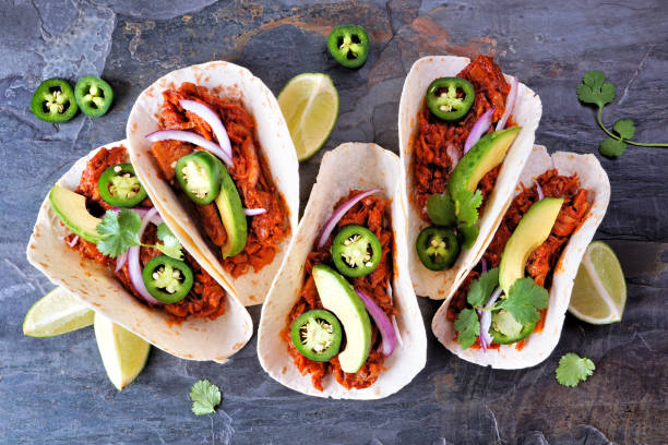 istock Jackfruit vegan tacos overhead view on a dark stone background 1462711815