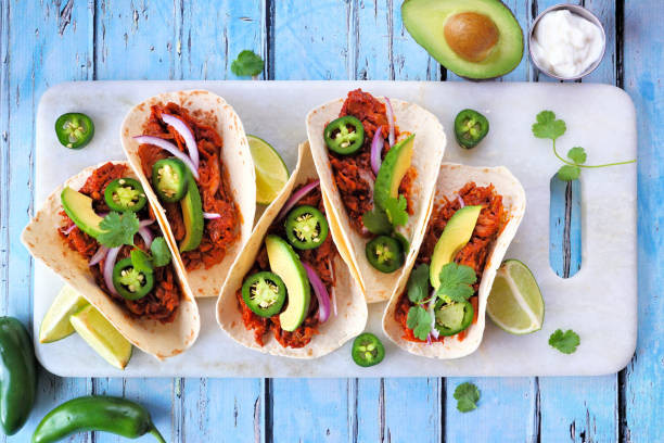 istock Jackfruit vegan tacos table scene over a rustic blue wood background 1462712420