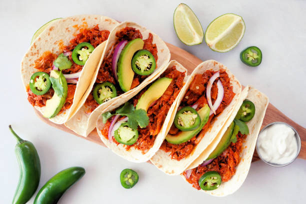 Jackfruit vegan tacos table scene on a white marble background stock photo