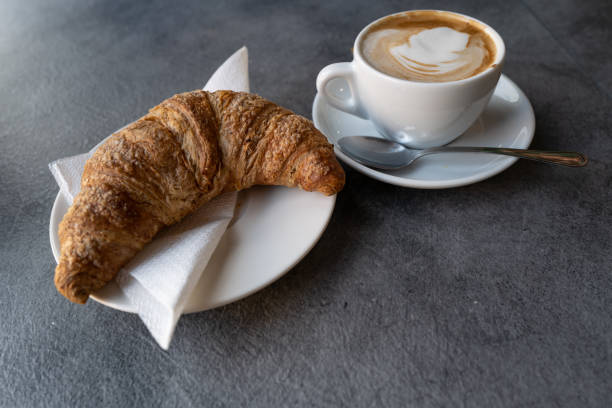 istock Italian caffe: cornetto and cappuccino at coffee bar 1462714092