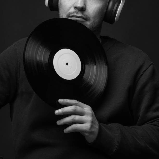 istock Man with sweatshirt headphones and LP vinyl studio portrait 1462714314