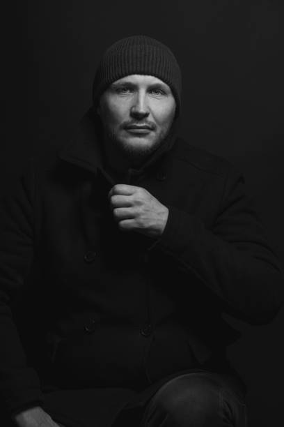 Portrait of a handsome man on a light background close-up cropped view of a black and white photograph model. High quality photo