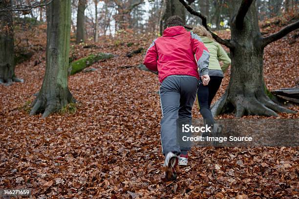 Mature Couple Jogging In Forest Stock Photo - Download Image Now - 45-49 Years, Active Lifestyle, Adult