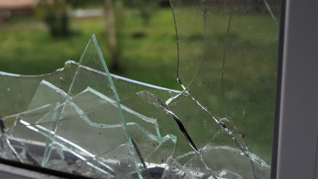 Large shards of glass in a broken window