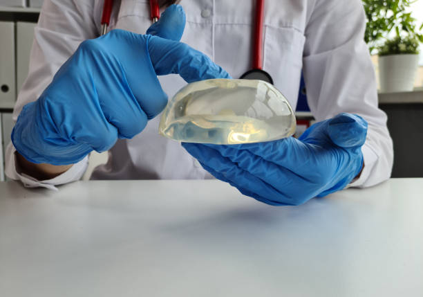 istock Doctor plastic surgeon touching silicone implant with finger 1462726216