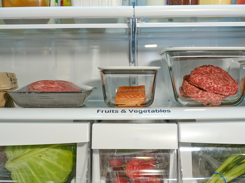 The inside of a refrigerator, with food stored in separate containers for safety.