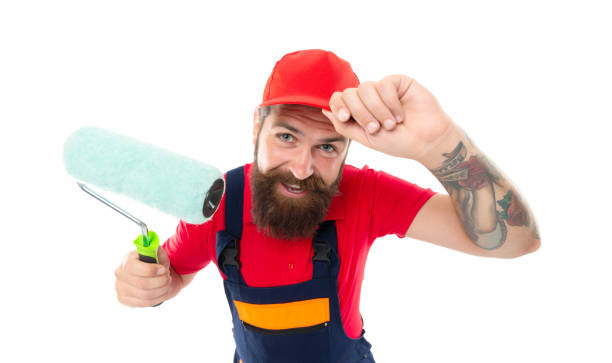 istock cheerful man painter with paintroller isolated on white background. man painter with paintroller. 1462734629