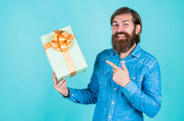 istock brutal bearded male man hold present or gift, holiday 1462746415
