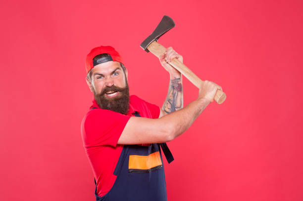 Brave enough. use blade in barbershop. Brutal and bearded. aggressive man with axe. forester hold the ax. man in uniform cut beard hair with ax. brutal bearded man use axe in hands. Hike vacation.