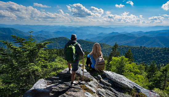 Catawba, Virginia, USA - September 1, 2014: Hikers enjoy the view of the Appalachian Mountains from McAfee Knob on Catawba Mountain, near Roanoke, Virginia. It is one of the most popular overlooks on the Appalachian Trail and is situated at an elevation is 3,171 feet.