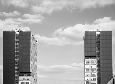 Two modern office building towers against the sky. Skyscrapers in Bucharest, Romania