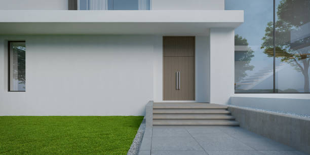 istock House entrance with white wall and lawn grass.3d rendering 1462759139