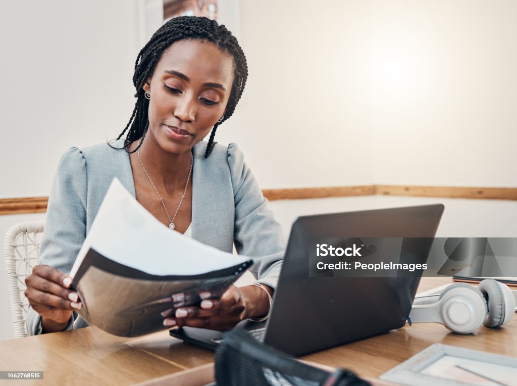 Black woman with business documents, small business entrepreneur working on strategy and planning online marketing. Learning startup industry vision, laptop for advertising company and technology job Examining Stock Photo