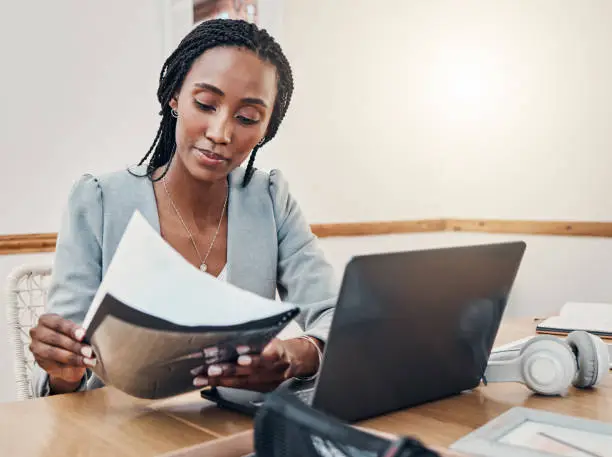 Photo of Black woman with business documents, small business entrepreneur working on strategy and planning online marketing. Learning startup industry vision, laptop for advertising company and technology job