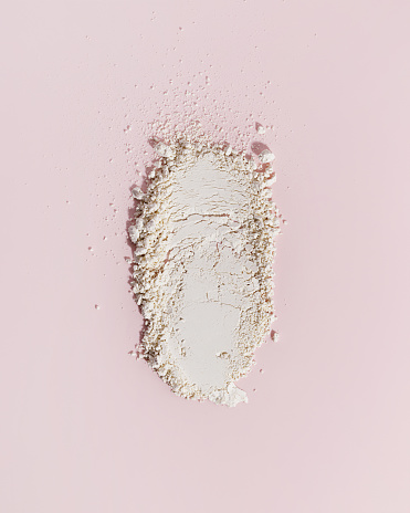Cosmetic clay. Clay facial mask on a pink background. Natural cosmetics for cosmetic procedures. Beauty concept.