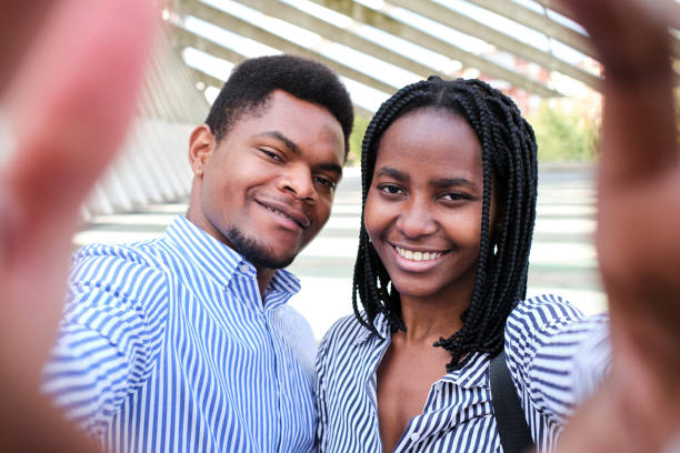 istock African businesspeople smiling at camera while taking a selfie outdoors 1462780697