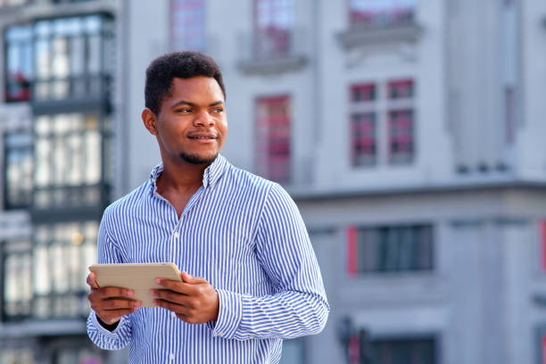 istock Distracted businessman holding a digital tablet outdoors 1462781036