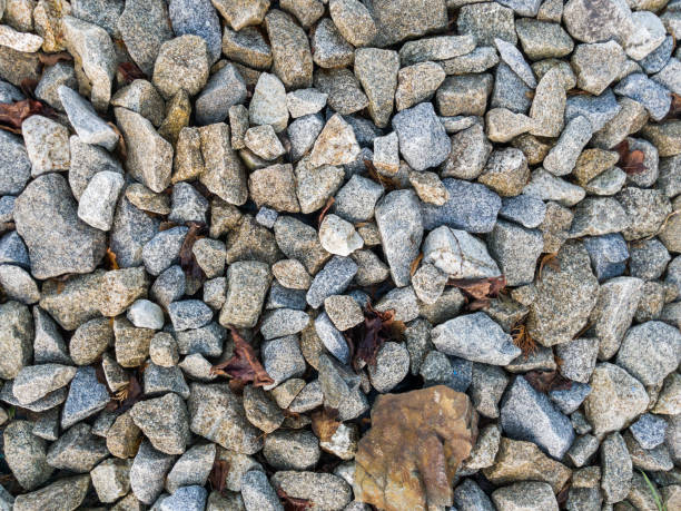 Crushed stone texture background. Coarse gravel. Granite crushed stone. Construction materials.\nThis image was taken with a mobile phone.