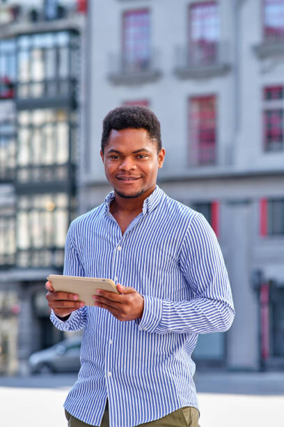 istock Smiley businessman using a digital tablet outdoors 1462781137