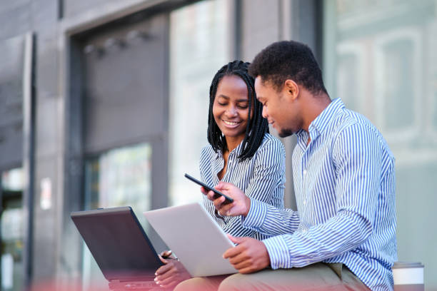 istock Business people using the mobile while working in remote outdoors 1462781554