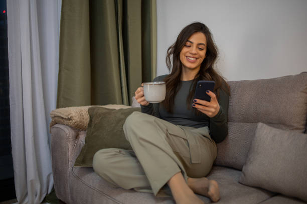 istock Happy young woman using phone 1462782402