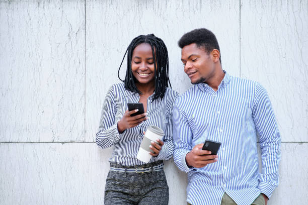 istock African business people using the mobile while holing a coffee 1462791718