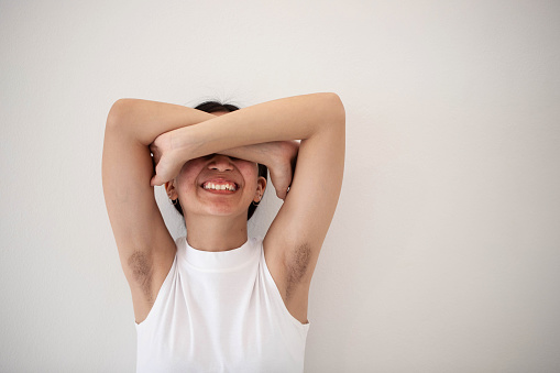 Young woman portrait showing armpit hair