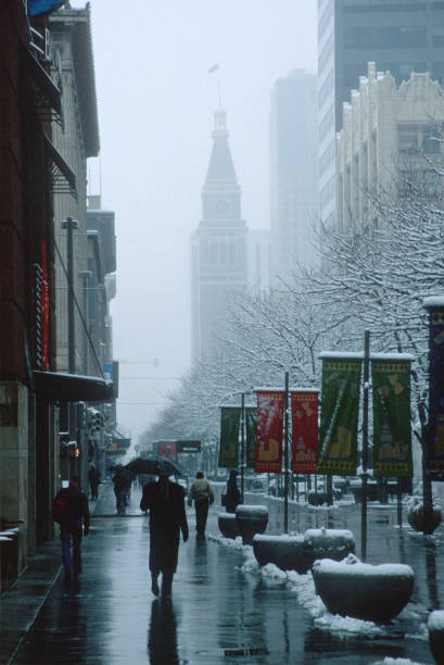Snowy downtown Denver 16th Street Mall historic May D&F clock tower Colorado stock photo