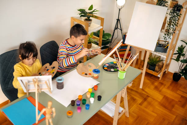 istock Two kids having fun on painting class 1462813576