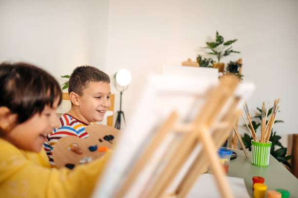 istock Two kids having fun on painting class 1462813597