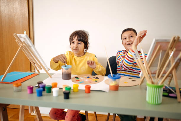 istock Two kids having fun on painting class 1462813628