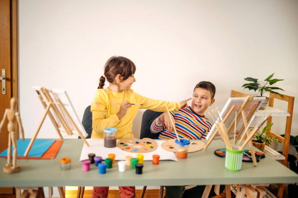 istock Two kids having fun on painting class 1462813639