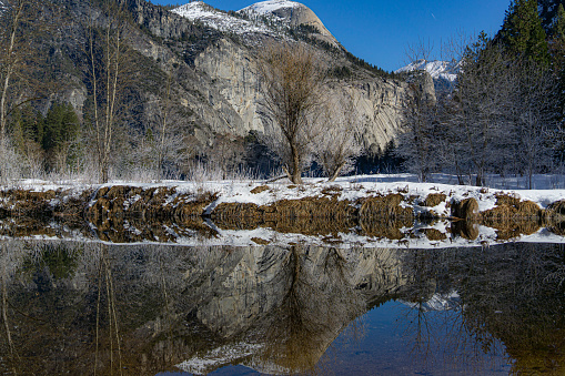 Yosemite National Park's snow mountain in the daytime with a reflection of itself