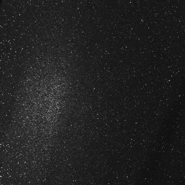 istock Black bokeh texture on black background. White glitter or illuminated dust 1462826247