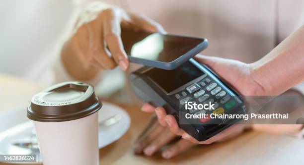 Close Up Contactless Payment Reader On Waitress Hand Give To Customer Scan From Smartphone To Paying Bill At Table In The Cafe Fr Technology Transaction Concept Stock Photo - Download Image Now