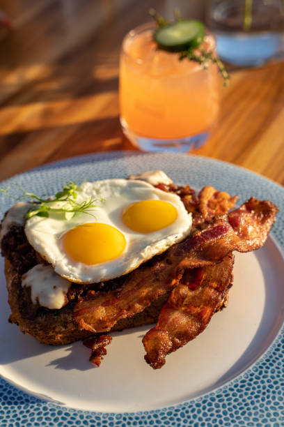 French Toast with bacon and two sunny-side eggs on top stock photo