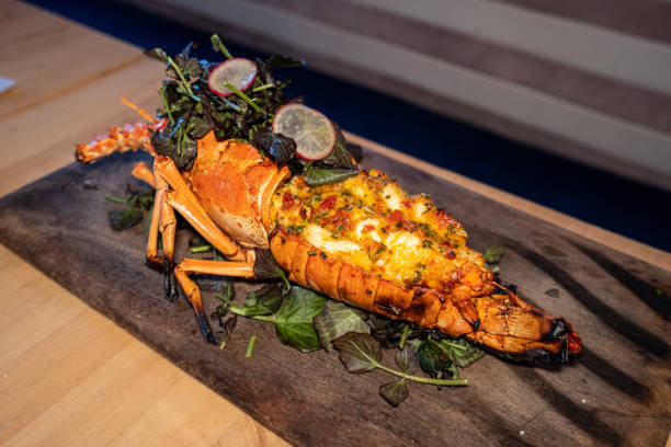 Grilled whole lobster on wooden board stock photo