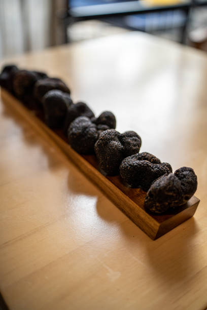 Australian Black Winter Truffles on wooden table stock photo