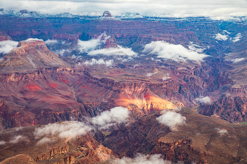 Winter canyon land scene in the Grand Canyon with clouds and mist.