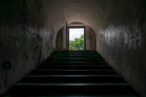 Entrance with dark staircase to underground tunnel connecting inside Tamansari water castle in Yogyakarta, Indonesia